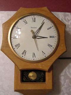 Vintage Electric United Wall Clock with pendulum. In working 