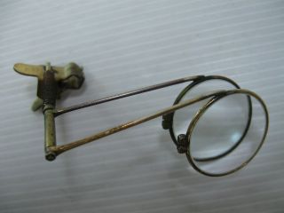 AN OLD BRASS AND MAGNIFYING GLASSES ATTACHMENT FOR MOST OLD TYPE 