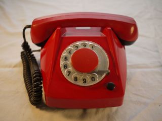 Antique vintage rotary red plastic phone from the 1970s looks cool
