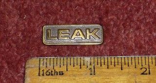 one vintage brass leak badge for speaker or valve amp