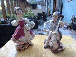 Pair Of Vintage Porcelain Figurines   Man Playing Cello   Lady Holding 