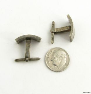 This pair of cuff links have curved faces with a polished finish each