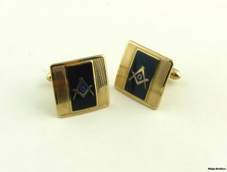 This pair of cuff links have square and compass emblems set on black