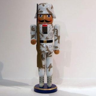 This decorative wooden Army soldier nutcracker holds a gun.Product