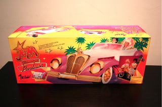 Up for auction is a Jem Glitter n Gold Roadster with box