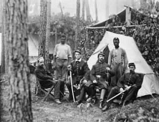 Four union officers in front of tent, with two Afro American Serva g2